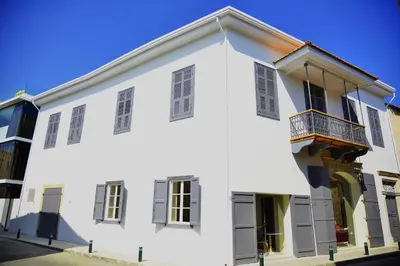 a white building with a balcony on a street at Lokàl Boutique Hotel in Larnaka