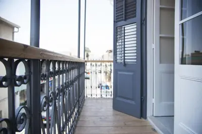 a balcony with a blue door and a wooden walkway at Lokàl Boutique Hotel in Larnaka