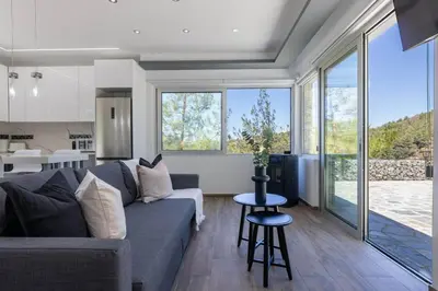 a living room with a couch and a table at Palaiomylos Forest Residence