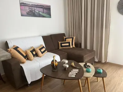 a living room with a couch and a table at Panos salt lake apartment in Aglantzia