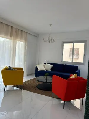 a living room with a blue couch and two chairs at Modern 3BR Family Apartment in Quiet Drosia with Balcony in Larnaka