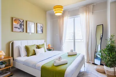 a bedroom with a bed with two towels on it at Mystique 1-Bedroom Apartment in Larnaka