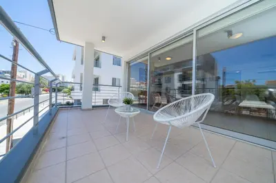 a balcony with chairs and tables on a building at Modern 2 bedroom flat in Engomi in Strovolos