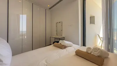 a bedroom with two towels sitting on a bed at Aqua Beachfront Villas - Villa 1 in Ayia Napa
