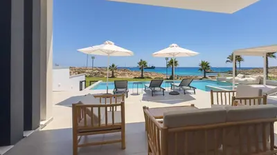 a view from the living room of a resort with a pool at Aqua Beachfront Villas - Villa 1 in Ayia Napa
