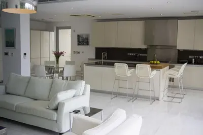 a living room and kitchen with a couch and chairs at Katerina House in Pervolia