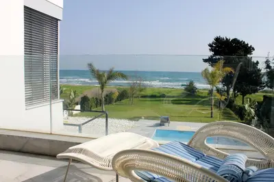 a patio with chairs and a view of the ocean at Katerina House in Pervolia