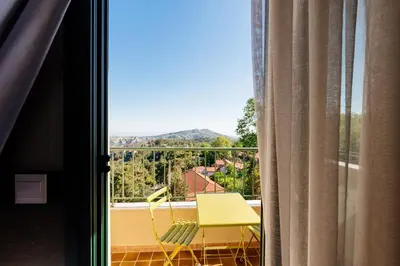 a room with a window with a table and chairs at Petit Palais Platres Boutique Hotel in Platres