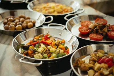 a bunch of pans filled with different types of food at Petit Palais Platres Boutique Hotel in Platres