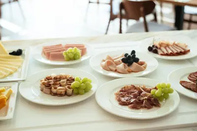 a table topped with plates of food and fruit at Petit Palais Platres Boutique Hotel in Platres