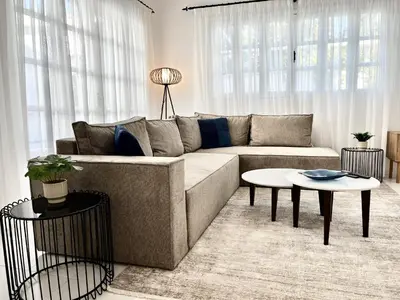a living room with a couch and a table at STAY Cavo Bay Villa in Protaras