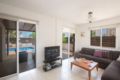 a living room with a couch and a tv at Mandali Villa in Protaras