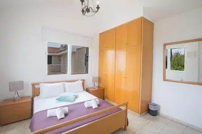 a bedroom with a bed with towels on it at Mandali Villa in Protaras