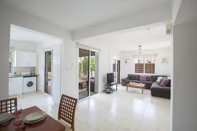 a living room with a couch and a table at Mandali Villa in Protaras