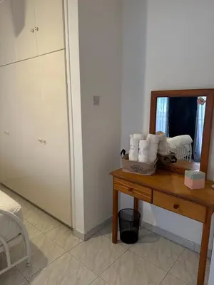 a room with a mirror and a table with towels at Sunny house in Larnaka