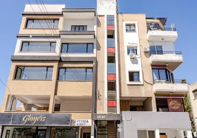 a tall building with a sign in front of it at Urban Bay Limassol in Limassol