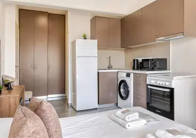 a kitchen with a white refrigerator and a dishwasher at Urban Bay Limassol in Limassol