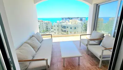 a living room with a couch and chairs and a large window at Rita Seaview - Agios Tychonas Four Seasons Area in Limassol