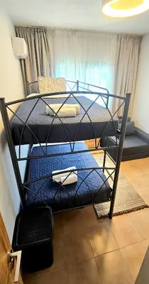 a bedroom with two bunk beds in a room at Rita Seaview - Agios Tychonas Four Seasons Area in Limassol