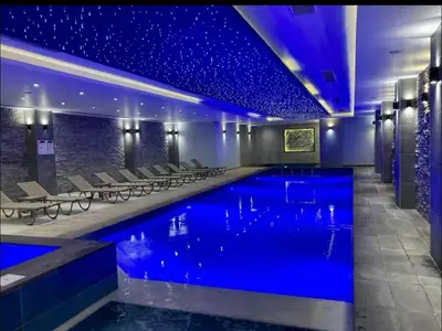 a pool in a hotel with blue lighting at Bedroom flat Caesar resort, Iskele north Cyprus in Vrysoules