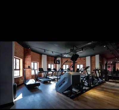 a gym with a bunch of treadmills and a tv at Bedroom flat Caesar resort, Iskele north Cyprus in Vrysoules