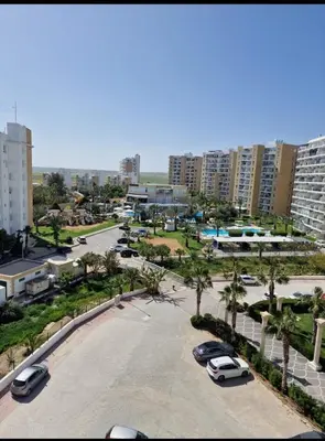 a parking lot with cars parked in a city at Bedroom flat Caesar resort, Iskele north Cyprus in Vrysoules