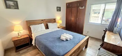 a bedroom with a bed with two pillows on it at Retro art and mirrors Molos in Limassol