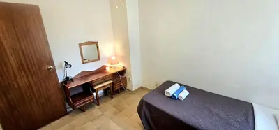 a bedroom with a bed and a desk with a mirror at Retro art and mirrors Molos in Limassol