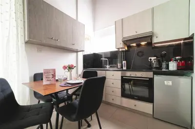 a kitchen with a table and chairs in a kitchen at Elite luxury Suites in Omodos