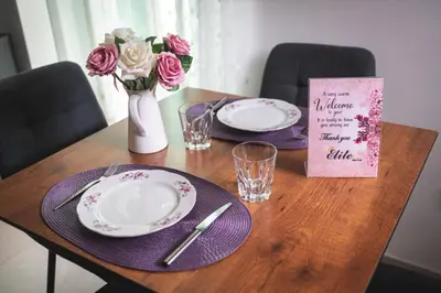 a wooden table with plates and a vase with flowers at Elite luxury Suites in Omodos