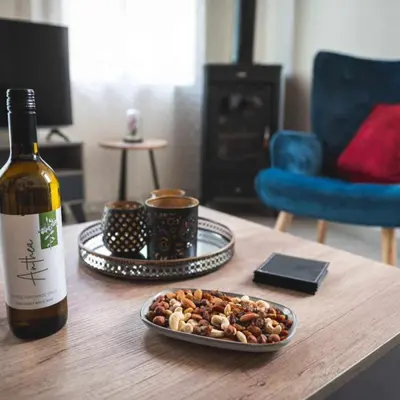 a bottle of wine and a plate of food on a table at Elite luxury Suites in Omodos