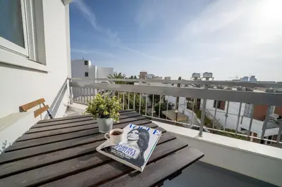 a table with a magazine and a book on a balcony at Central 2 bedroom flat in Nicosia