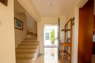 a hallway with stairs in a house at Frontline Sea-View Villa in Paralimni