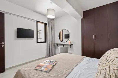 a bedroom with a bed with a magazine on it at Aether Residence by Nomads in Tersephanou