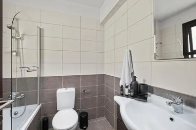 a bathroom with a toilet and a sink and a shower at Aether Residence by Nomads in Tersephanou