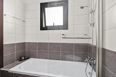 a bath tub in a bathroom with a window at Aether Residence by Nomads in Tersephanou