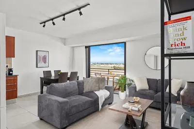 a living room with a couch and a table at Aether Residence by Nomads in Tersephanou
