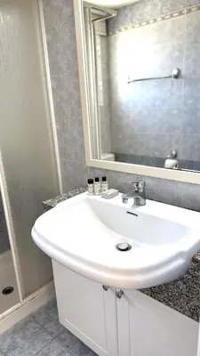 a bathroom with a white sink and a mirror at Modern 3BDR_Top Floor_Lux_Suite_Balcony in Limassol