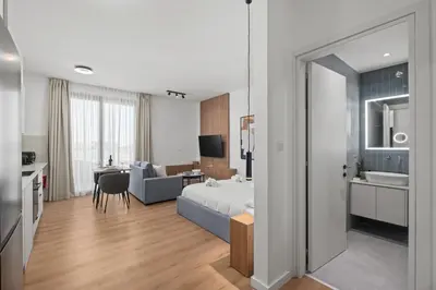 a bedroom with a bed and a living room at Artemis 205 - Seaside Stories in Livadhia