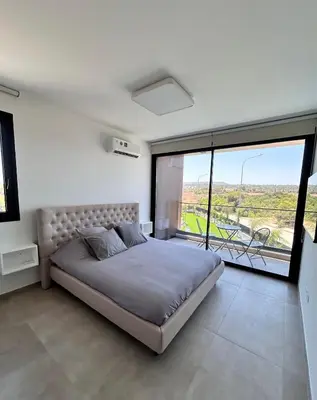 a bedroom with a large bed and a large window at Luxury Elegant Home in Protaras