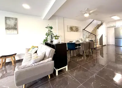 a living room with a couch and a table at Elegant Beach Villa Moonstone II in Meneou