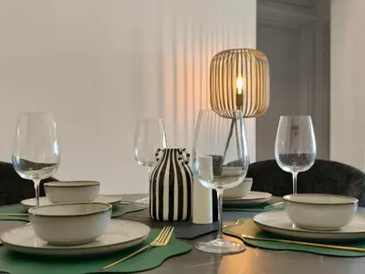 a table with plates and wine glasses on it at Joyscape beachfront residence in Larnaka