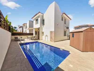 a swimming pool in the backyard of a house at Villa Rena - 3BR Retreat near Kalamies Beach in Paralimni
