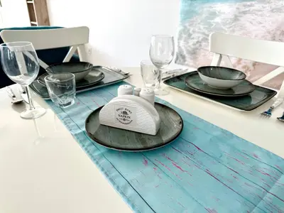 a table with two glasses and a plate on it at Majestic Sea View Apartment in Tersephanou