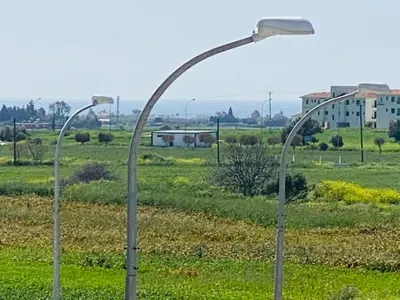 two street lights in the middle of a field at Majestic Sea View Apartment in Tersephanou