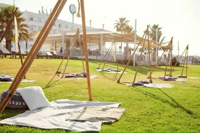 a group of swings in a field of grass at Piere - Anne Beach Hotel in Ayia Napa