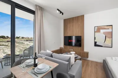 a living room with a couch and a table at Artemis 106 - Seaside Stories in Livadhia