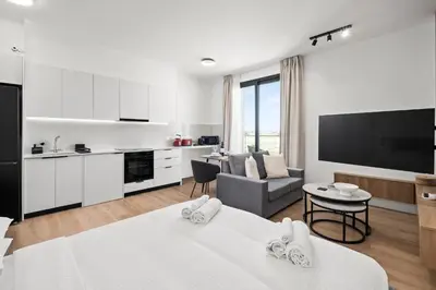 a room with two beds and a kitchen and a living room at Artemis 106 - Seaside Stories in Livadhia