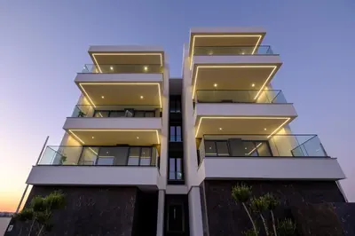 a tall white building with balconies on it at Artemis 106 - Seaside Stories in Livadhia