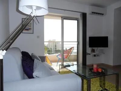 a living room with a couch and a glass table at Eden Beach Apartment 611 in Limassol